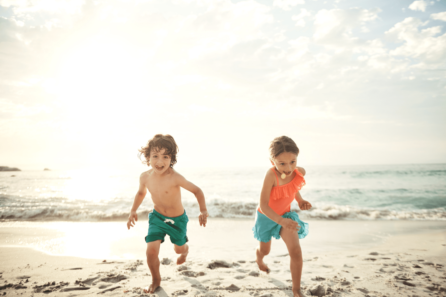 children playing happily on beach